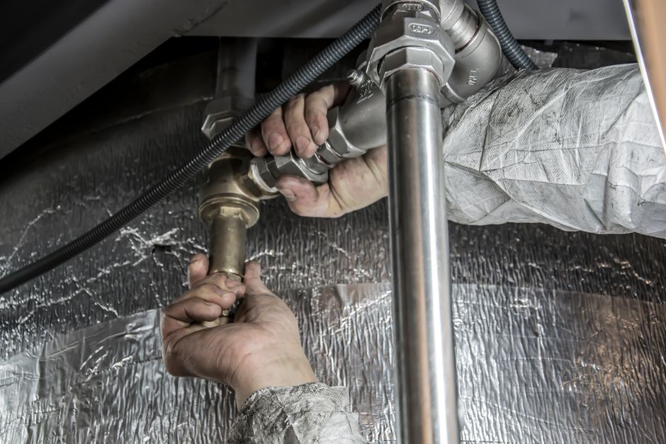 Technician using a pneumatic impact wrench for tire installation