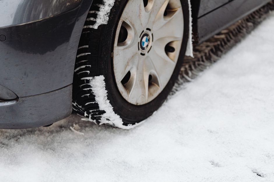 Mechanic carefully checking tire tread depth