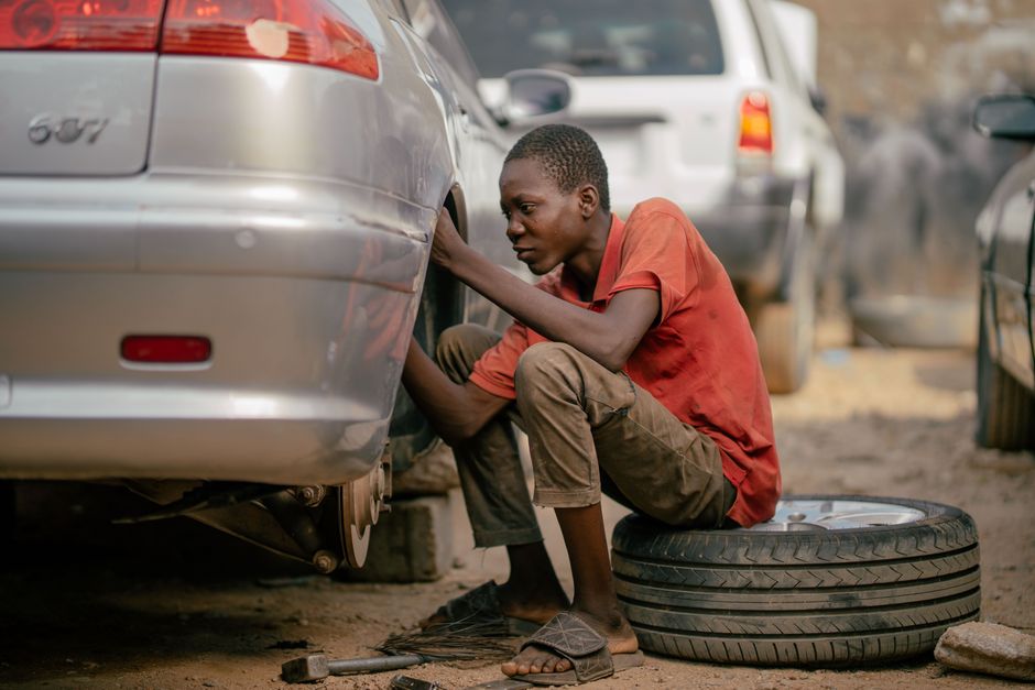 Mechanic professionally changing a car tire in a modern shop